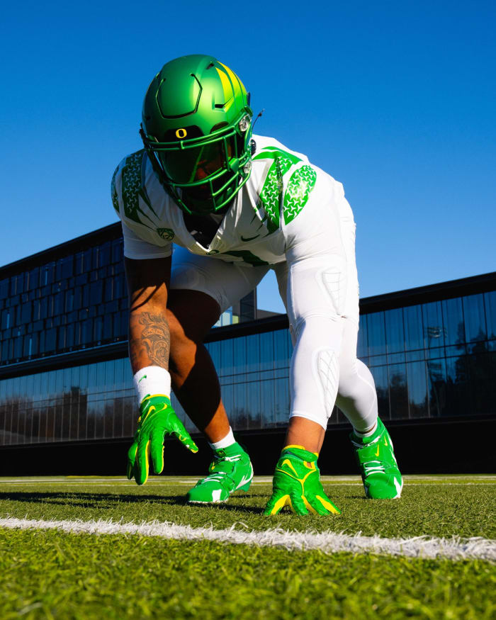 Oregon Ducks defensive lineman Brandon Dorlus models a uniform for the Pac-12 Championship against Washington.